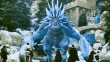 a group of people are standing in front of a dragon with ice spikes on its head