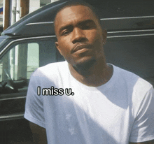 a man wearing a white shirt that says i miss u