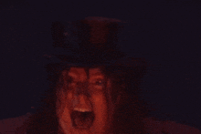 a woman in a top hat is screaming with her mouth wide open