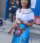 a girl wearing glasses and a blue skirt is holding a cup of coffee