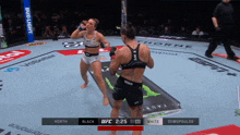 two women are fighting in a boxing ring with a bud light banner on the side