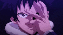 a close up of a person covering their eyes with their hands