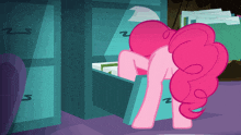 a pink pony is looking in a drawer with the letter z visible