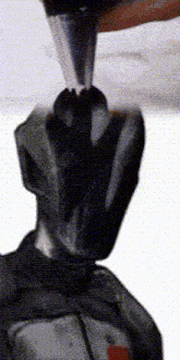 a person is using a piping bag to frost a cake