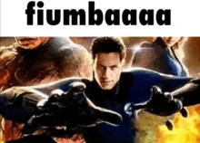a man in a superhero costume is giving a thumbs up while standing in front of a group of people .