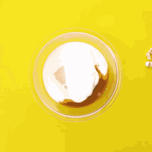 a person is pouring liquid into a cake pan filled with popcorn