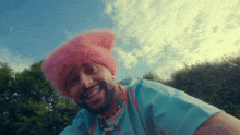 a man wearing a pink hat and a blue shirt