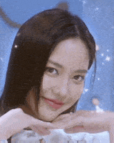 a woman is making a heart shape with her hands