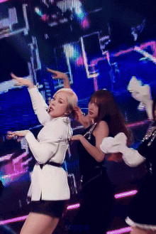 a group of women are dancing on a stage and the word soppa is on the bottom left