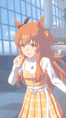 a girl with long orange hair is wearing a yellow plaid dress