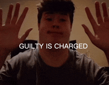 a man with his hands up and the words guilty is charged above him