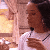 a woman in a white sweater holds a cell phone
