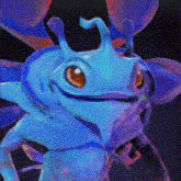 a close up of a blue cartoon character with a big smile on its face