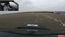 a man in a helmet is driving a car on a track with thinki jules written on the bottom