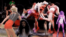 a group of women are dancing on a stage and one of them is wearing a shirt that says 11