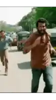 a man with a beard is running down a street with another man
