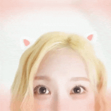 a close up of a woman 's eyes with cat ears on her head
