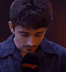a man holding a microphone with the word oooh written on it