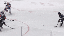 a hockey game is being played in front of an advertisement for verizon
