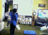 a woman in a blue shirt stands in a living room