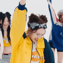 a woman wearing a yellow jacket with the word ien on it