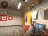 a person holding a gun in front of a red sign that says b