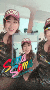 a woman wearing a yo8 hat is smiling in a mirror