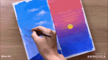 a person is painting a sunset on a piece of paper with the words wow art below it