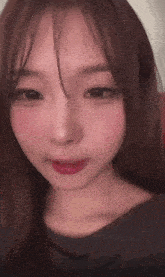 a close up of a girl 's face with a gray shirt on
