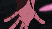 a person 's hand is holding a pink beam of light