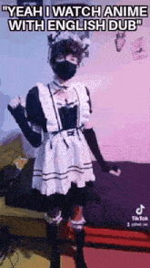 a person wearing a maid costume and a mask is standing in front of a bed .