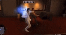a man in a white suit is dancing in a living room with a clock displaying the time of 03:12:06