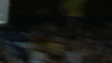 a blurred image of a basketball player in a blue jersey