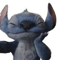 a stuffed animal with its eyes closed looks like stitch