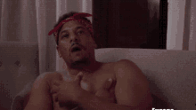 a shirtless man with a bandana on his head is called eugene the gangster evangelist