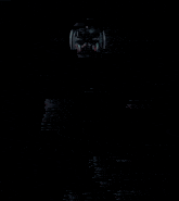 a man in a superhero costume is standing in front of a wall holding a gun .