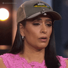 a woman wearing a hat that says dragonfly