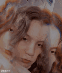 a close up of a person 's face with a reflection of another person 's face .