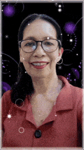 a woman wearing glasses and a red shirt smiles