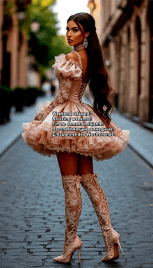 a woman in a dress and boots is walking down a street