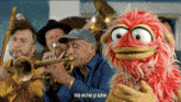 a group of men playing instruments with a red puppet in front of them