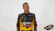 a man in a rush truck centers uniform looks up at the sky