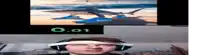 a man wearing headphones is looking at a screen with a shark on it