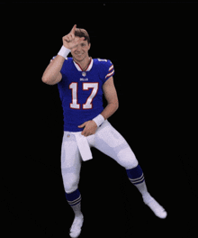 a football player with the number 17 on his jersey is dancing