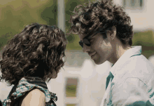 a man and woman are looking into each others eyes