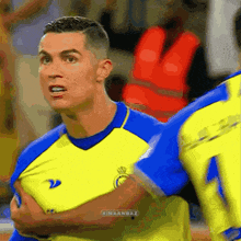 a soccer player wearing a yellow and blue jersey with the number 22 on the front
