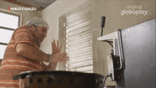a man is washing his hands in front of a globeplay ad