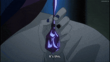 a person holding a purple bottle that says it 's this on it