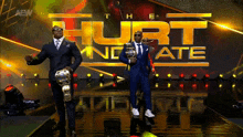a couple of men standing on a stage with the words hurt incarnate behind them