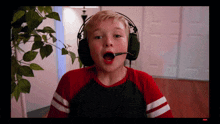 a boy wearing headphones with a microphone on his head